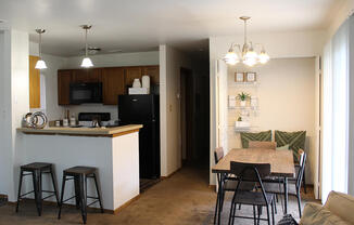 a view of the kitchen and living room in a bedroom plus den unit