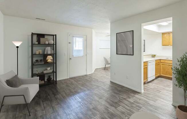 A living room with a white chair and a black floor lamp.