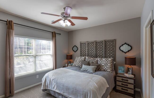 a bedroom with a bed and a ceiling fan