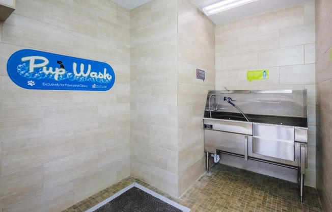 a public washroom with a sink and a tub in a public restroom