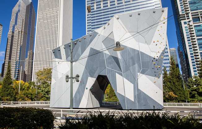 a triangular building in a city with tall skyscrapers