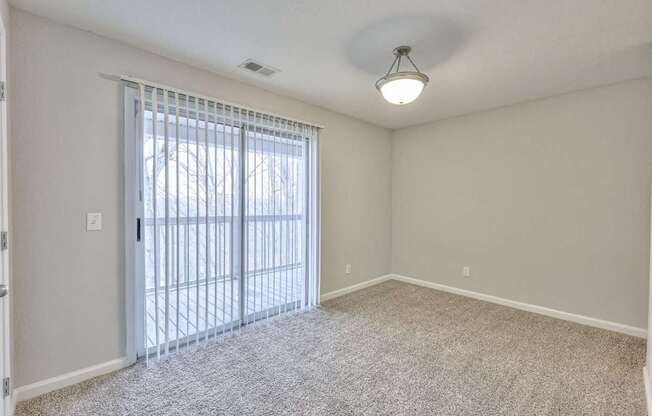 A room with a sliding glass door leading outside at Landmark at Lyncrest Reserve Apartments, Nashville, TN
