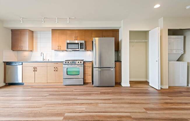 A kitchen with wooden floors and stainless steel appliances.