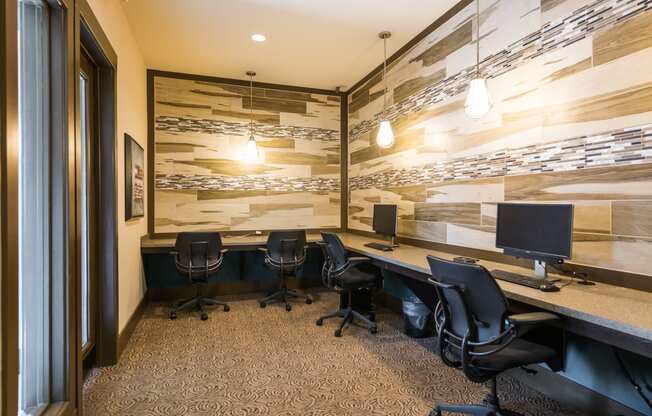 a conference room with desks and chairs and a wall of wood paneling