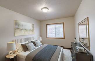 a bedroom with a bed and a dresser and a window. Moorhead, MN South Park Apartments
