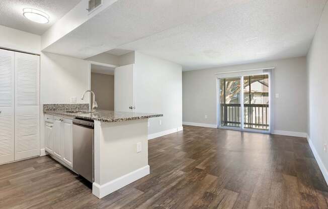 Model living room with wood-style flooring at Seven Lakes at Carrollwood in Tampa, Florida.