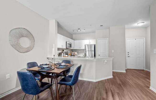 A kitchen with a dining table and chairs.