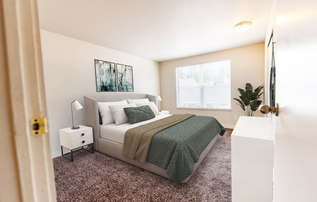 A bedroom with a bed, nightstand, and lamp.