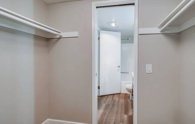 A white door is open to a bathroom.