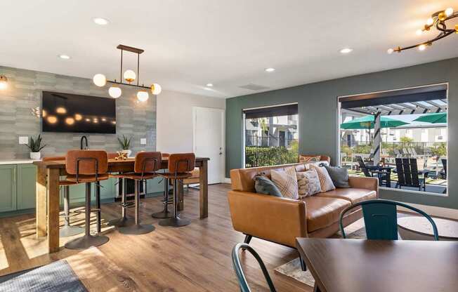 A modern dining room with a wooden table and chairs.