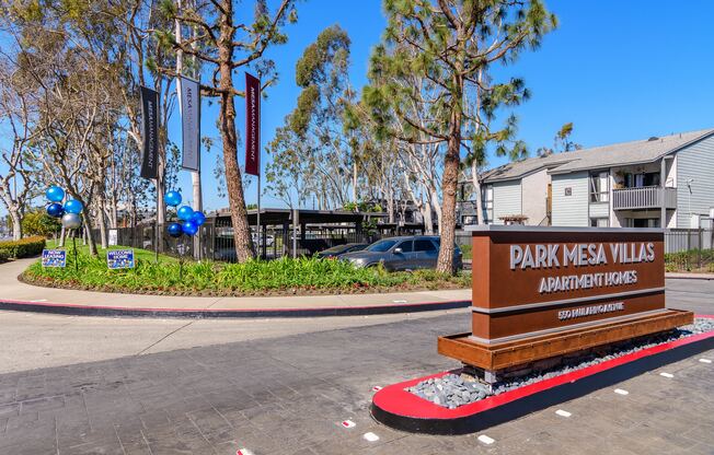 A sign for Park Mesa Villas Apartment Homes is in front of a building.