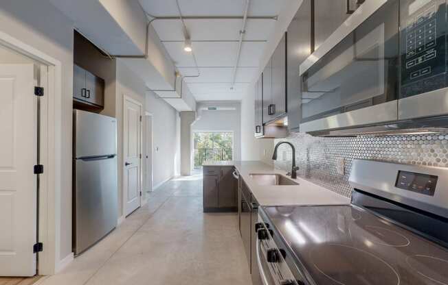 a kitchen with stainless steel appliances and a stainless steel counter top