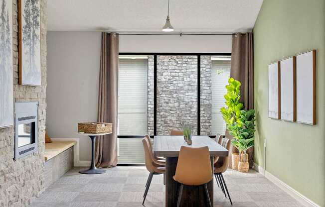 A dining room with a table and chairs.