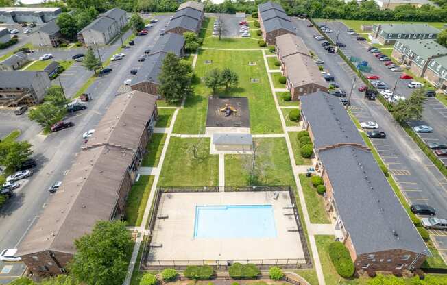 an aerial view of a row of houses with a basketball court in the middle of the yard