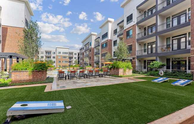 A sunny day at a residential complex with a trampoline in the foreground.