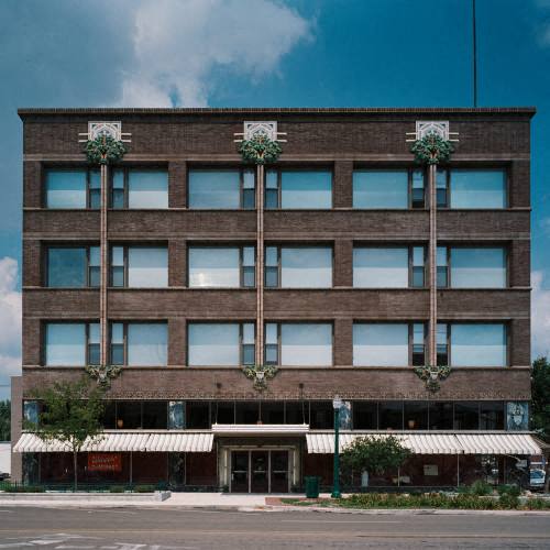 a tall brick building on the side of a street