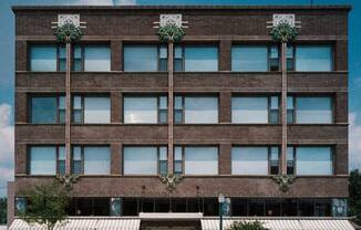 a tall brick building on the side of a street