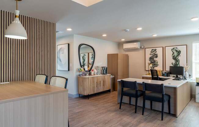 A modern office with a striped wallpaper and a wooden desk.