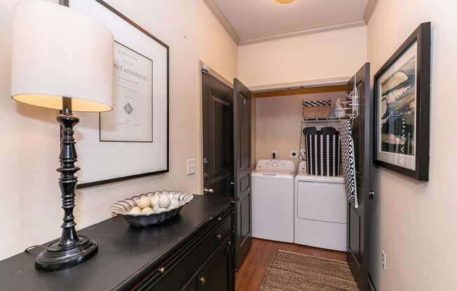 A black table with a lamp and a bowl of eggs on it.