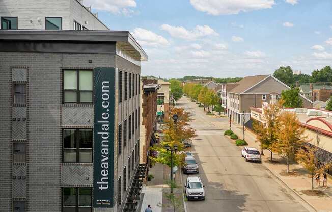 A street view of a town with cars and buildings.