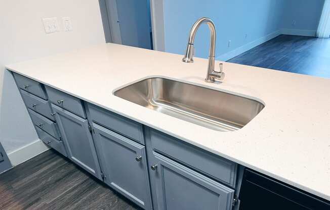 an empty kitchen counter with a sink and a faucet