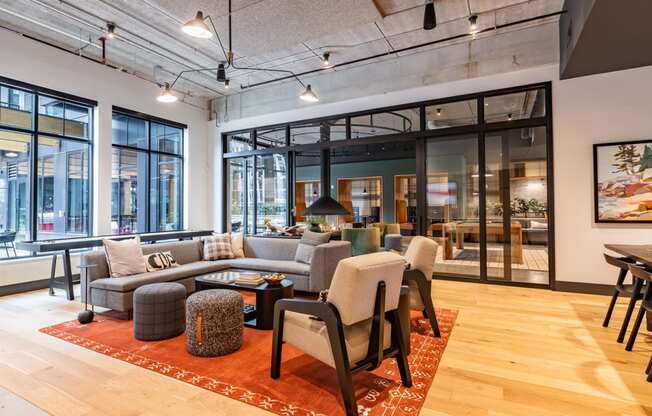 a living room with a couch and chairs in a lobby