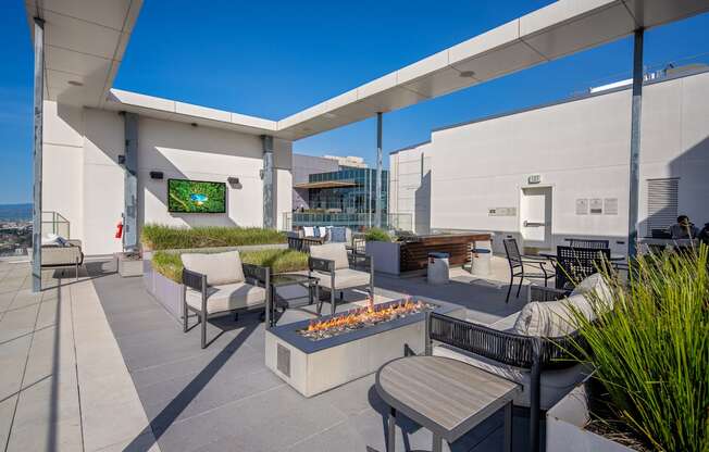 A patio with a fire pit and seating area.