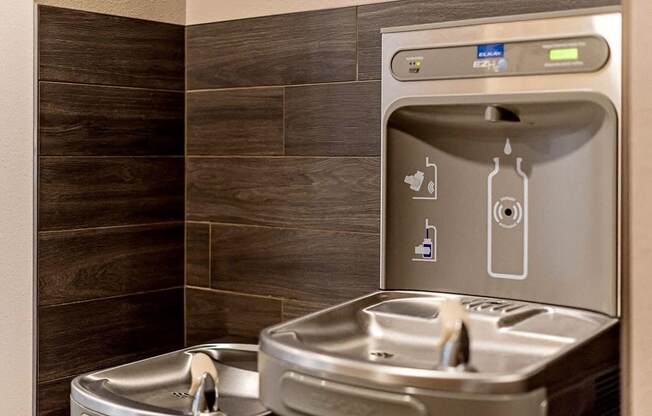 an image of a drinking fountain with water bottle refill station