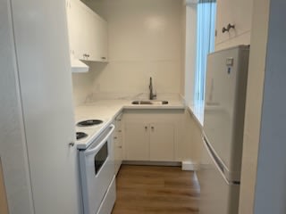 a small kitchen with a stove and a refrigerator