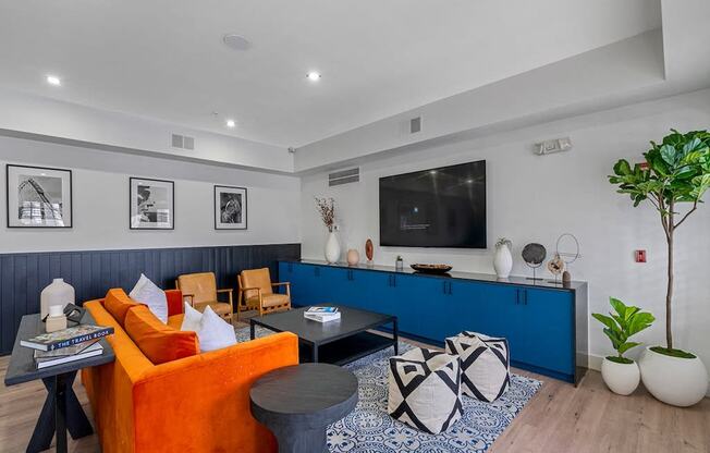 a living room with a blue and orange couch and a television