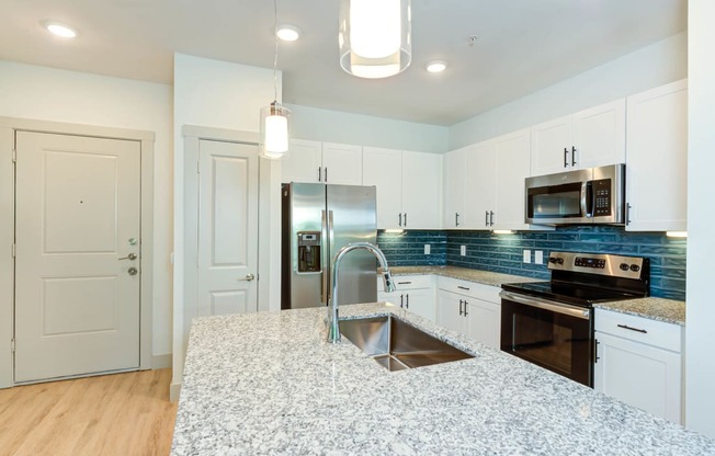 a kitchen with white cabinets and a counter top at Legacy at Cibolo, Boerne, TX