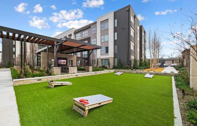 a grassy area with benches in front of some buildings