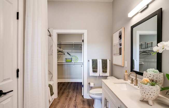 a bathroom with a shower and a sink and a toilet