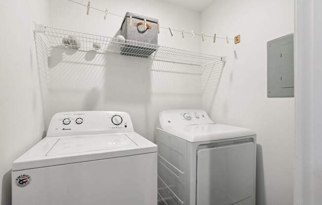 A white washing machine and dryer in a small laundry room.