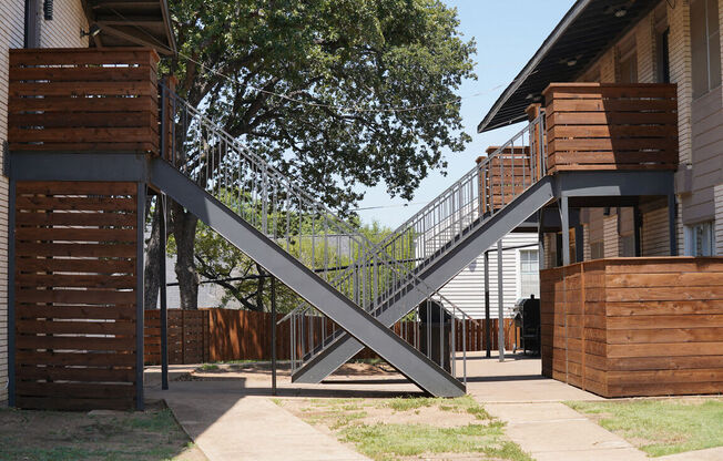 a steel bridge connects two buildings in a yard