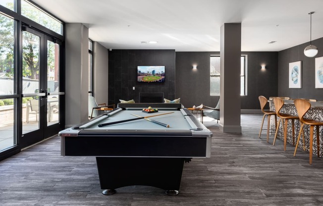 Hibernia resident lounge with pool table, large TV, and built-in fireplace