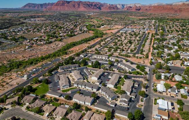 an aerial view of a suburban neighborhood with mountains in the background