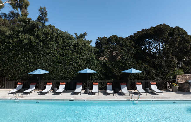 Pool with chairs and umbrellas next to a pool at Ascend2300, Carlsbad, CA, 92008