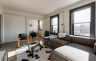 a living room with a couch and a glass coffee table