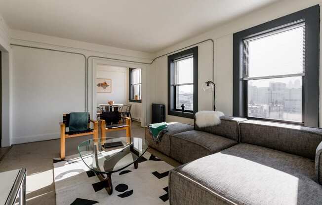 a living room with a couch and a glass coffee table