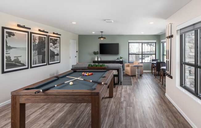 a games room with a pool table and a tv