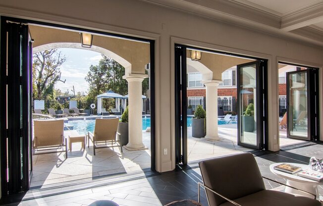 Clubhouse with large doors to open during nice weather going out to pool