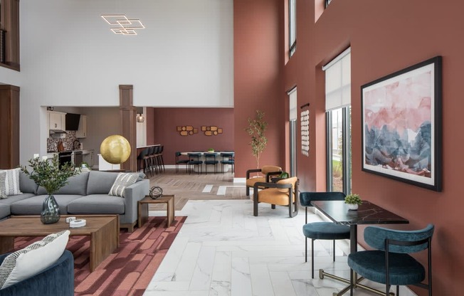 A modern living room with a grey sofa, a wooden coffee table, and a large painting on the wall.