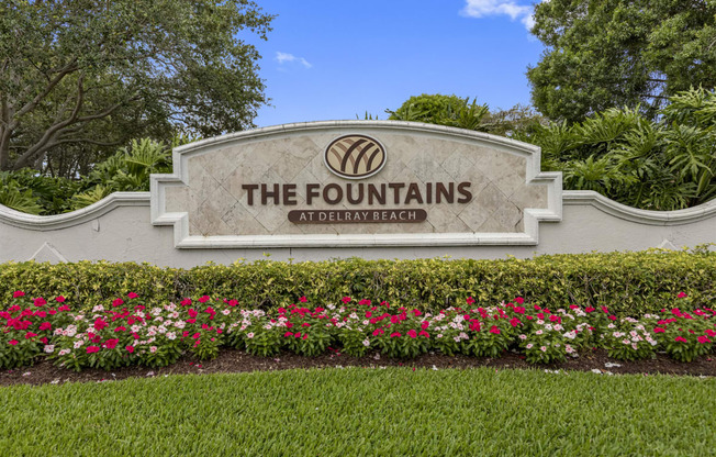 the fountains sign with flowers in front of it