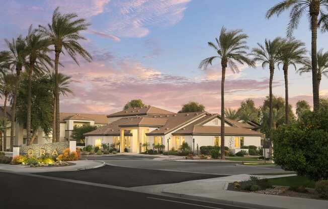 a street view of a house with palm trees