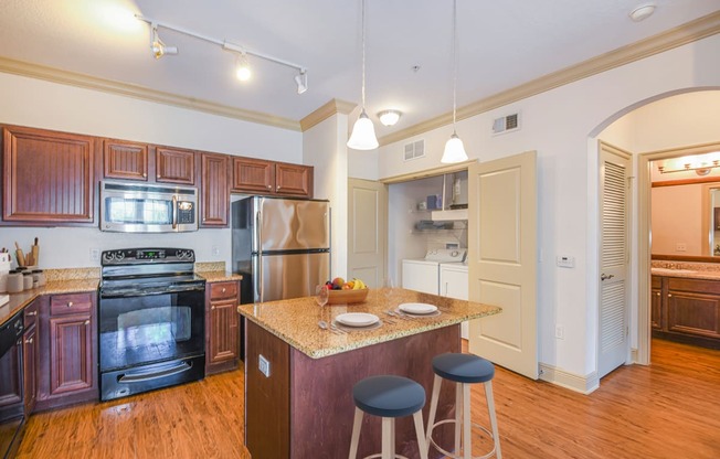 a kitchen with a center island with three stools