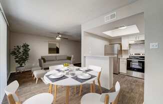 a living room and dining room with a white table and chairs