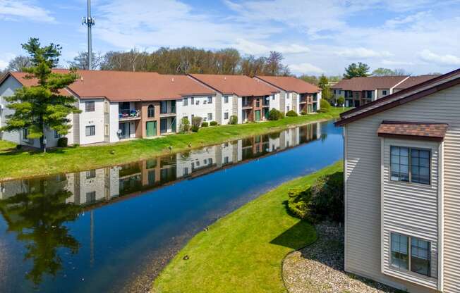 a group of houses next to a body of water