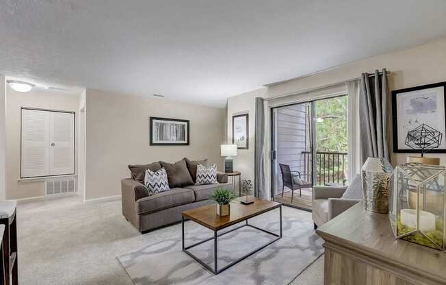 A living room with a couch, a coffee table, and a painting on the wall.