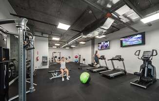 Gym with treadmills, an elliptical, weight machines, free weights, benches, an exercise ball and tvs at 6 Wood Flats, Lacey, WA